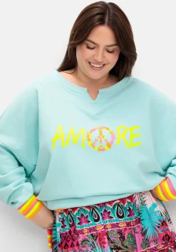 Sweatshirt mit Statementprint und Ringelbündchen<sheego loves miss goodlife Hot